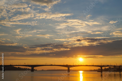 Beautiful orange sunset over the bridge on the Volga river in Kostroma