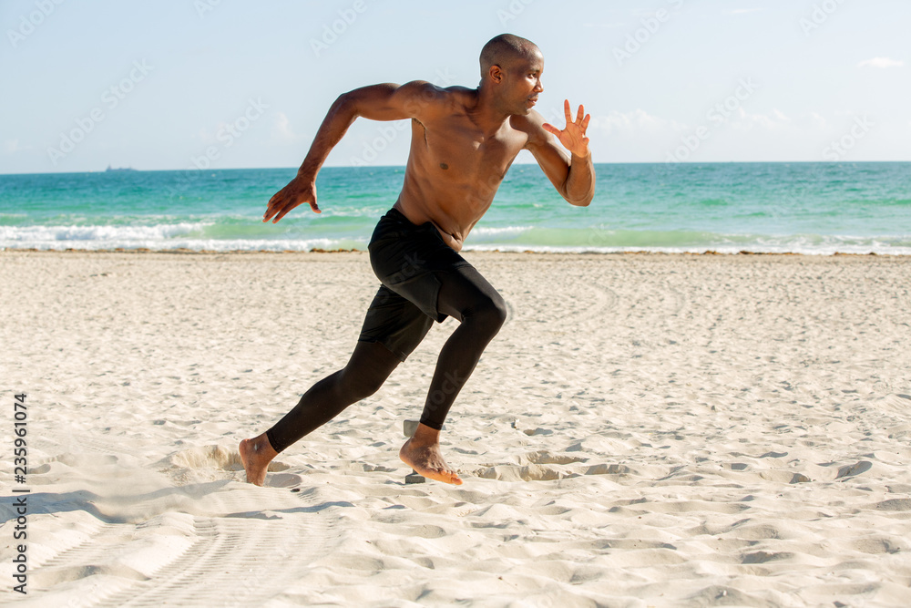 Young man running on the beach Young man running on the beach