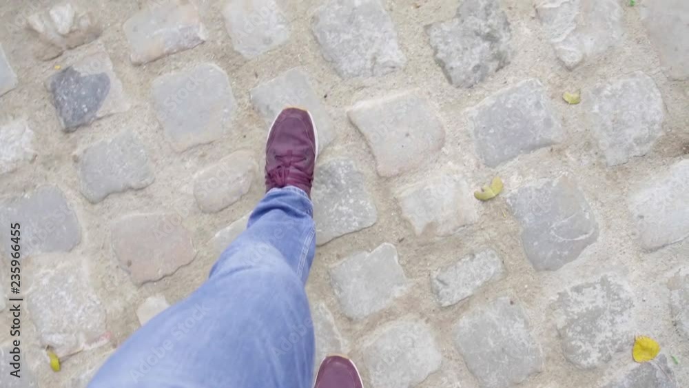 Shot from above of woman's legs walking in city on pavement, taking a stroll alone. Shot from above of woman's legs walking in city on pavement, taking a stroll alone.
