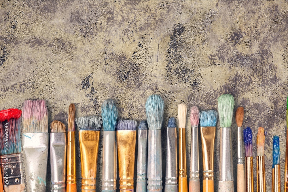 Row of artist paint brushes  on background - obrazy, fototapety, plakaty 