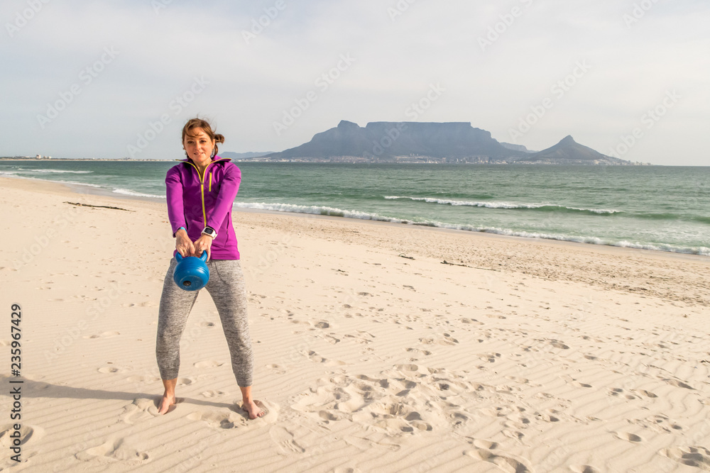 Fitness model exercising in front of table mountain