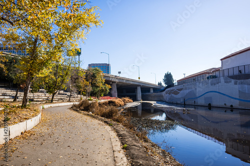 Paved walking path following the shoreline of Guadalupe river close to the downtown area, San Jose, south San Francisco bay area, California photo