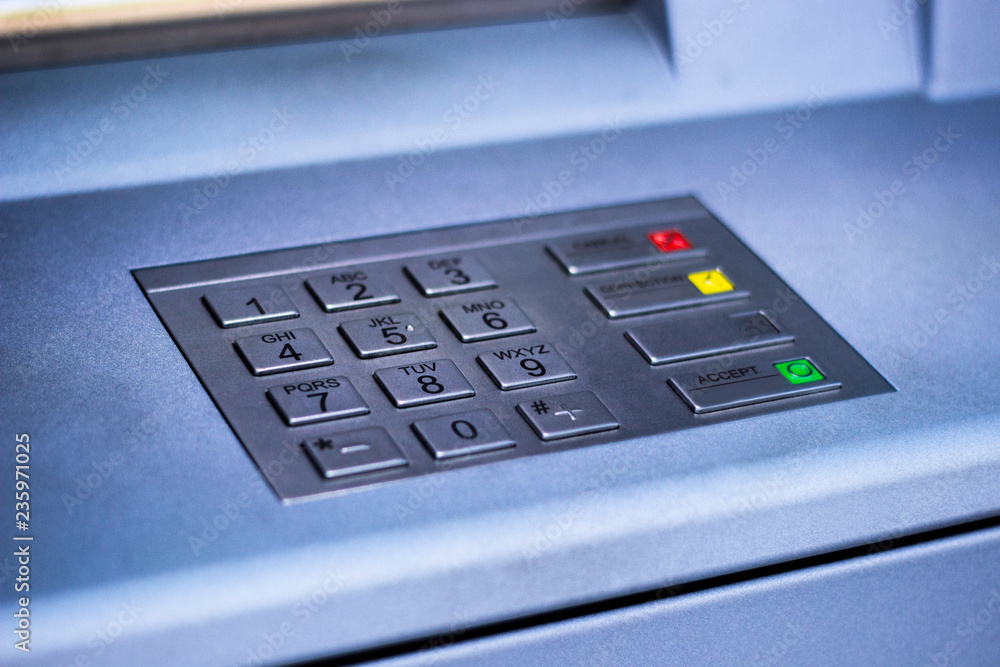 Entering personal identification number on ATM Entering personal identification number on ATM