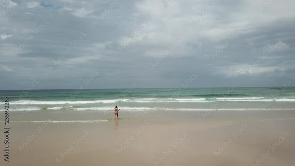 Lonely girl walking in a beach Lonely girl walking in a beach