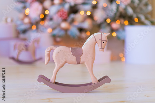 Photography Vintage pink rocking horse in the Christmas interior