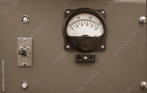 Retro devices on a wooden wall. Vintage measuring tools in a barn. Old phones.