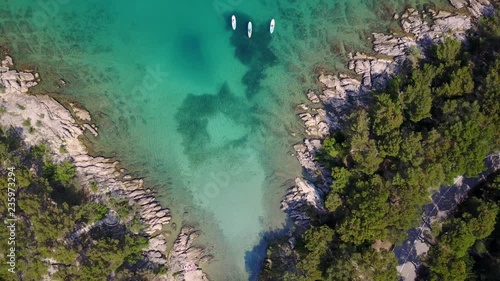 Aerial drone footage of amazing clean ocean, beautiful bay and group of paddle boards. photo