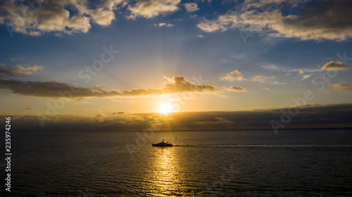 Ocean with sail ship and sunset © Ian