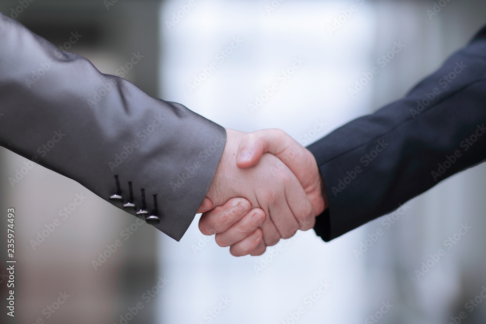 Close up.handshake of business partners on the background of the office