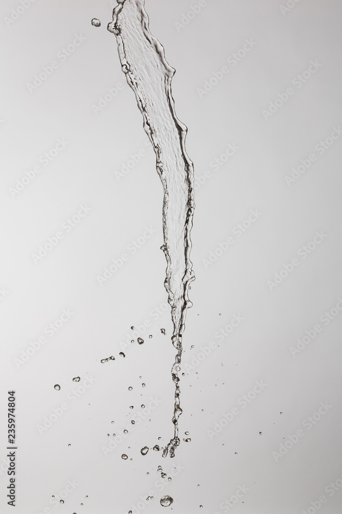 water splash with a lot of drops on a gray background water splash with a lot of drops on a gray background