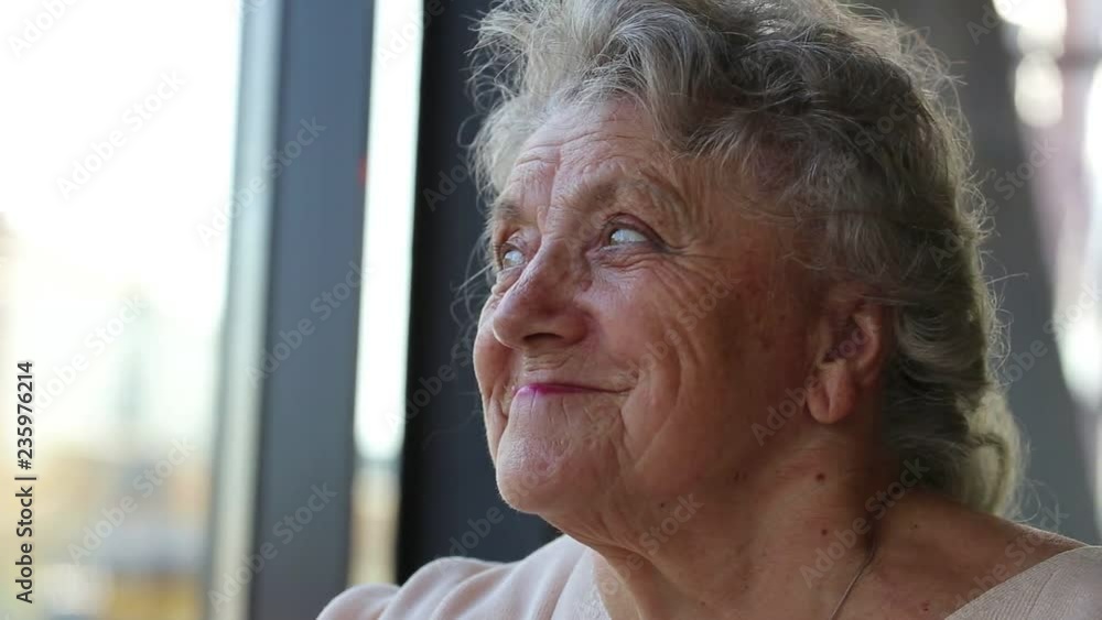Smile and looking emotion elderly woman on a light background Smile and looking emotion elderly woman on a light background