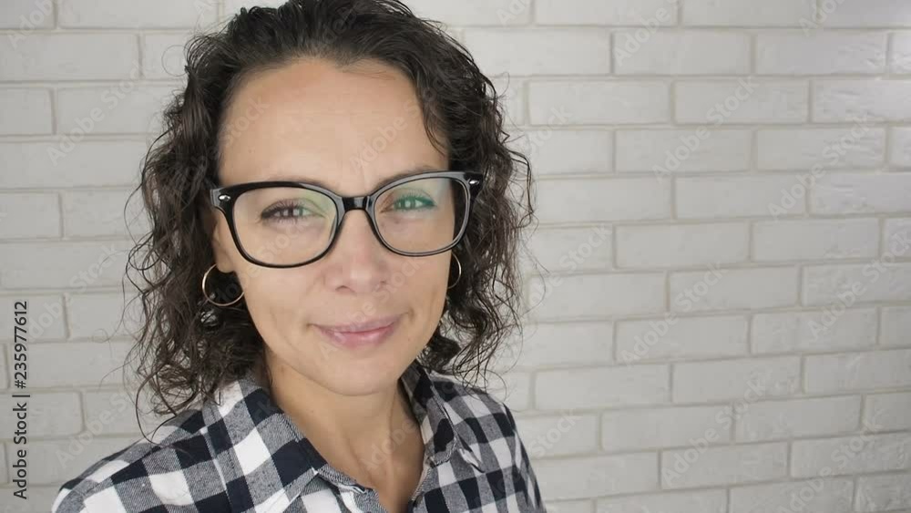 Portrait of a happy woman with glasses. A woman with glasses for vision looks into the camera. Portrait of a happy woman with glasses. A woman with glasses for vision looks into the camera.