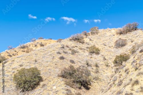 Dry hillside for hiking into blue sky and room for copy text