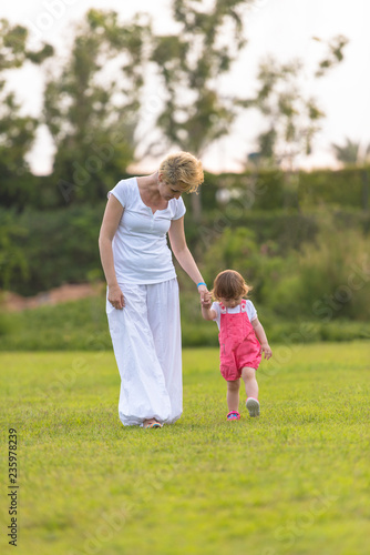 mother and little daughter playing at backyard