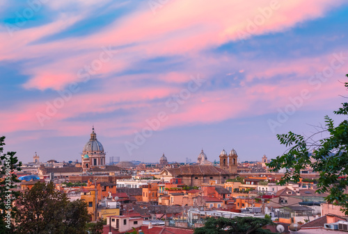 Aerial wonderful view of Rome with roofs and churches at sunset time in Rome, Italy © Kavalenkava