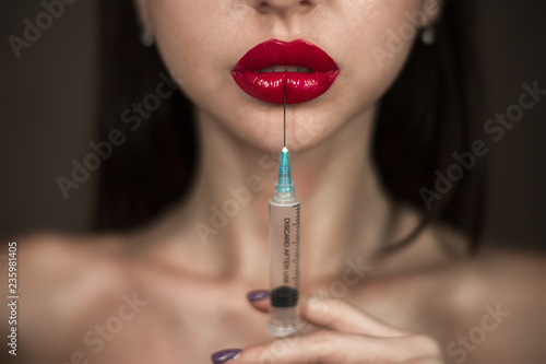 The portrait of the woman with red lipstick isolated on the dark gray brown background