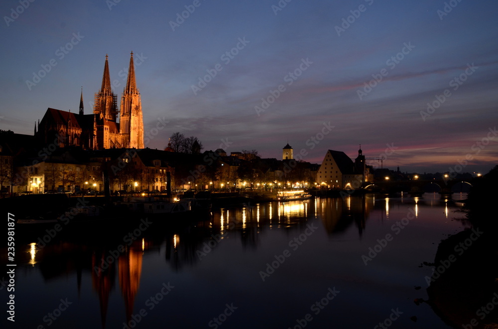 Stone Bridge and Cathedral in Regensburg, Germany by night