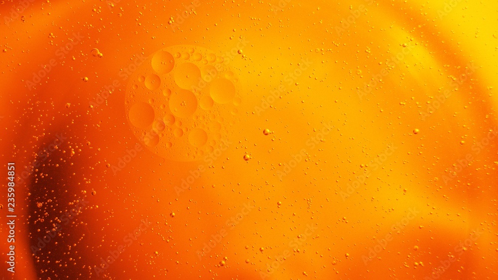 Yellow bubbles and drops of oil and water, beer and beverage texture background.