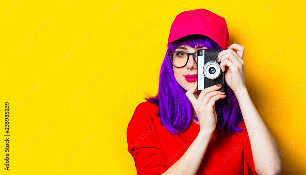 portrait of beautiful smiling young woman with retro camera on the wonderful yellow studio background portrait of beautiful smiling young woman with retro camera on the wonderful yellow studio background