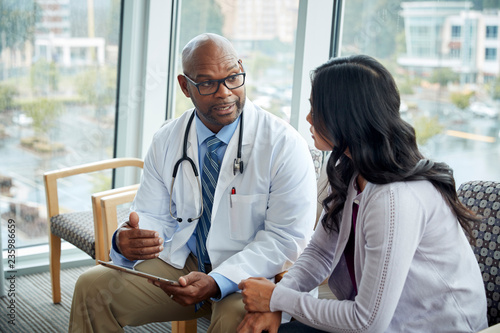 Doctor talking to woman in medical office