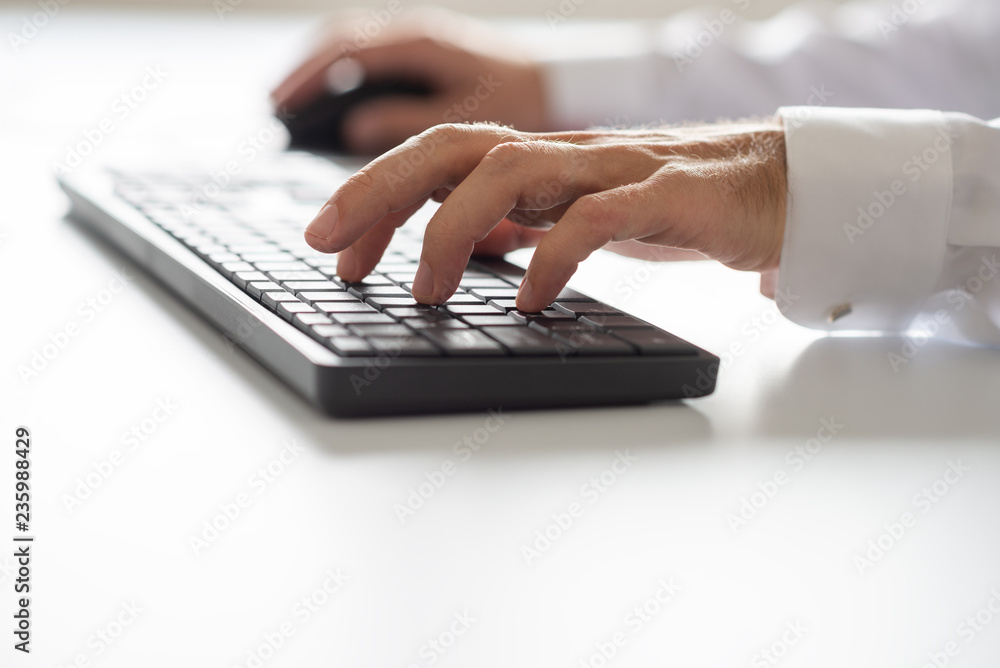 Closeup view of male hand using computer keyboard Closeup view of male hand using computer keyboard