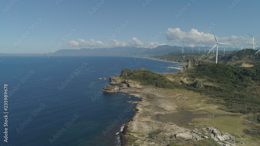 Aerial view of Windmills for electric power production on the coast. Bangui Windmills in Ilocos Norte, Philippines. Ecological landscape: Windmills, sea, mountains. Pagudpud