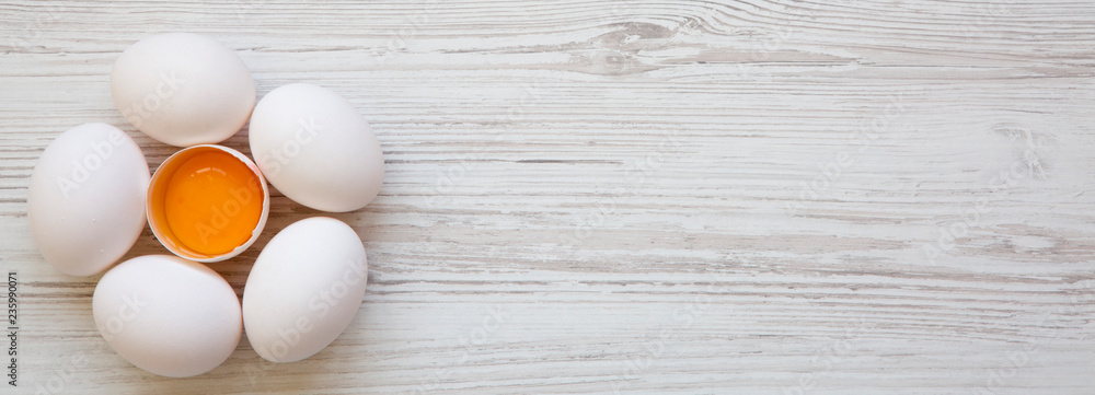Chicken eggs on white wooden surface, overhead view. Space for text. Chicken eggs on white wooden surface, overhead view. Space for text.