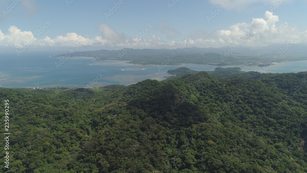Obraz premium Aerial view of coast of a tropical island Palau with wild beach. Mountains covered with rainforest and trees. Santa Ana, Philippines.