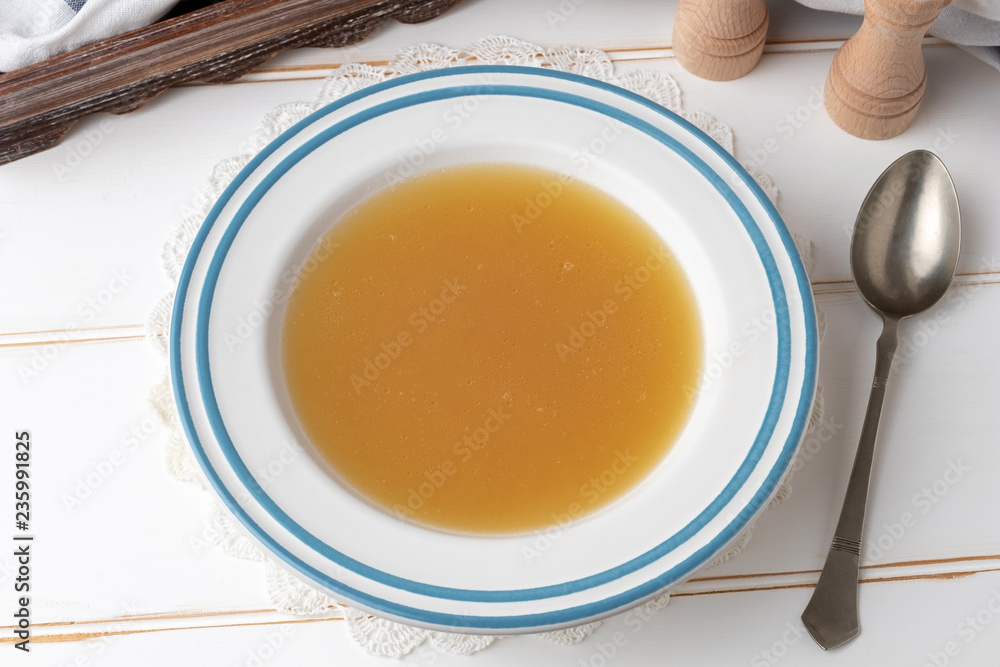 Chicken bone broth in a white plate Chicken bone broth in a white plate