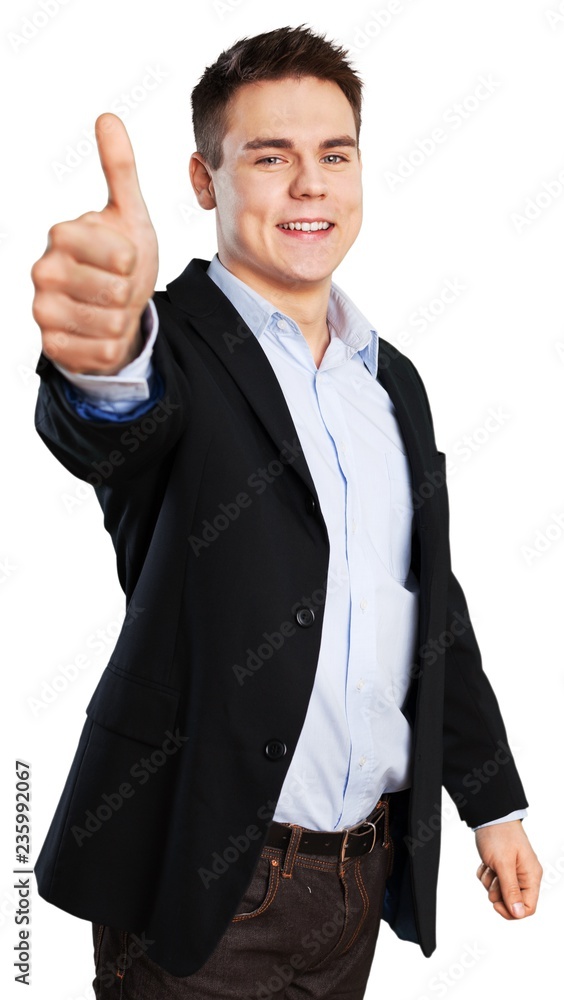 smiling young man giving a thumbs up smiling young man giving a thumbs up