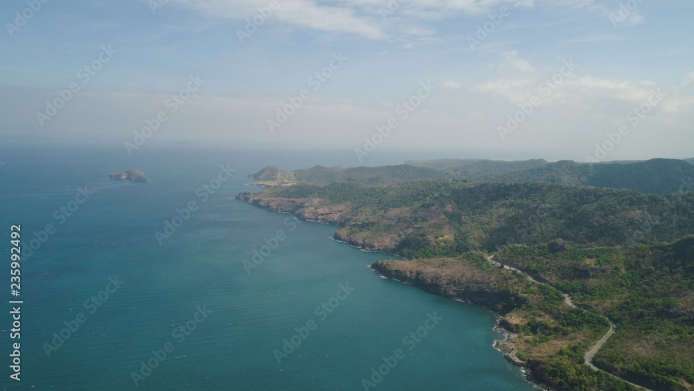 Aerial view of seashore with lagoons and coral reefs. Philippines, Luzon. Coast ocean with turquoise water. Tropical landscape in Asia.