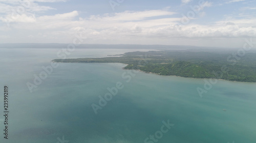 Aerial view of seashore with beach  lagoons and coral reefs. Philippines  Luzon. Ocean coastline with turquoise water. Tropical landscape in Asia.