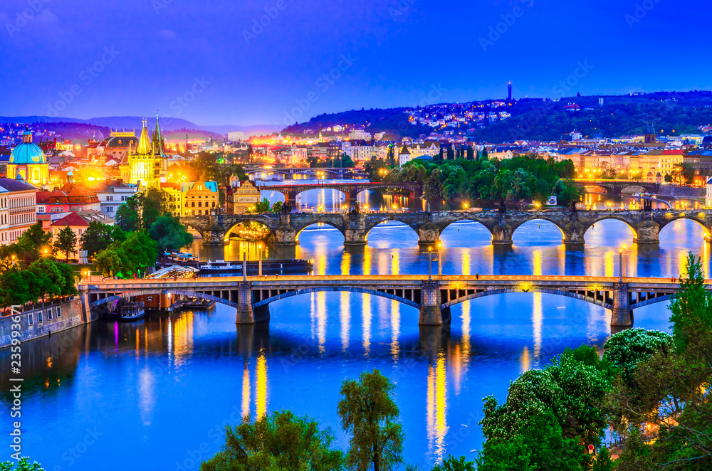 Fototapeta premium Prague, Czech republic: Night view over the Vltava river and its bridges at sunset