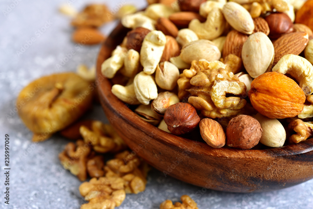 Wooden bowl with nuts ( pistachio, walnut, hazelnut, cashew, almond) and dried fruits. Wooden bowl with nuts ( pistachio, walnut, hazelnut, cashew, almond) and dried fruits.