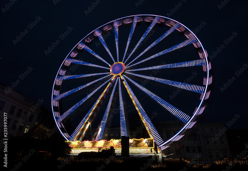 Big ferris wheel in blurred motion at night, copy space