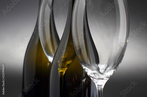 two empty wine glasses and two bottle close-up