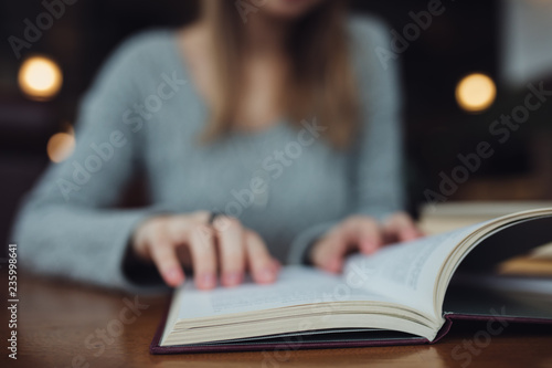 Woman reading book close up