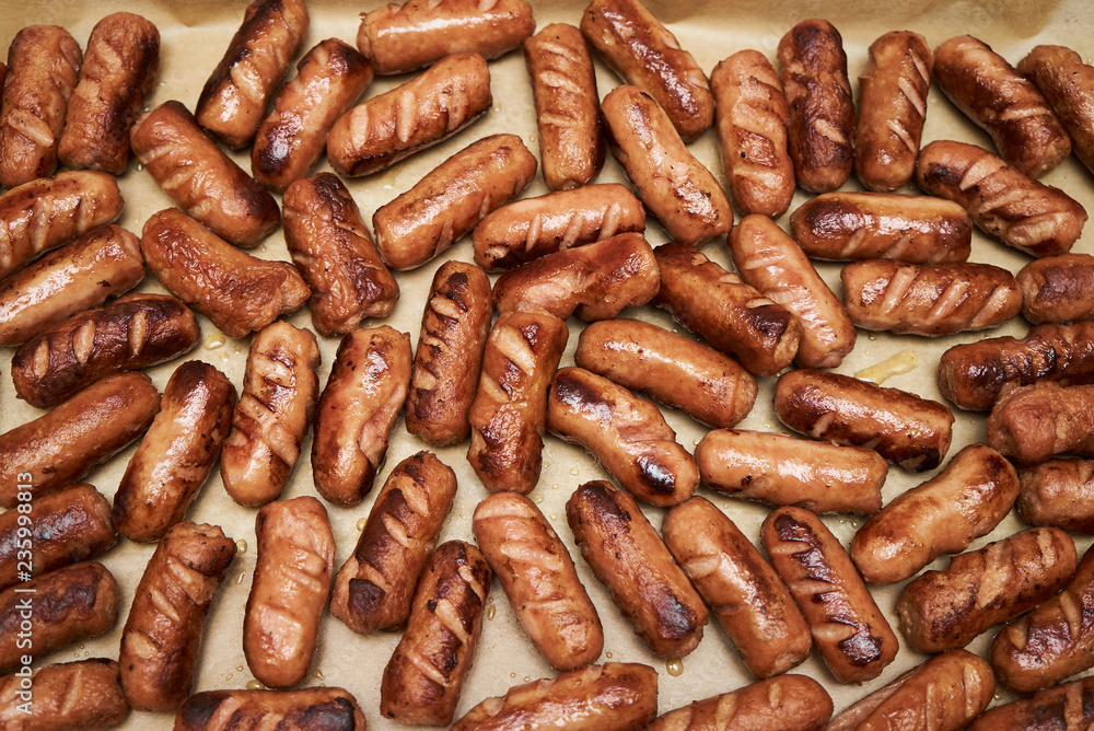 Grilled sausages background, close-up. Barbecue fried sausages Grilled sausages background, close-up. Barbecue fried sausages