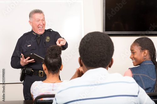 Officer teaching community outreach class full of students