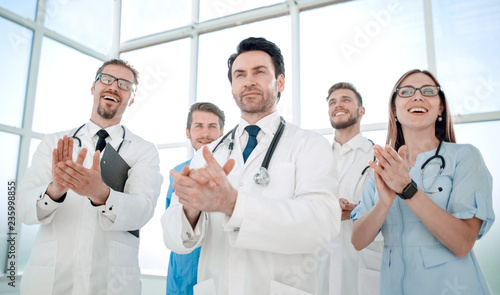 Five different doctors standing and applauding