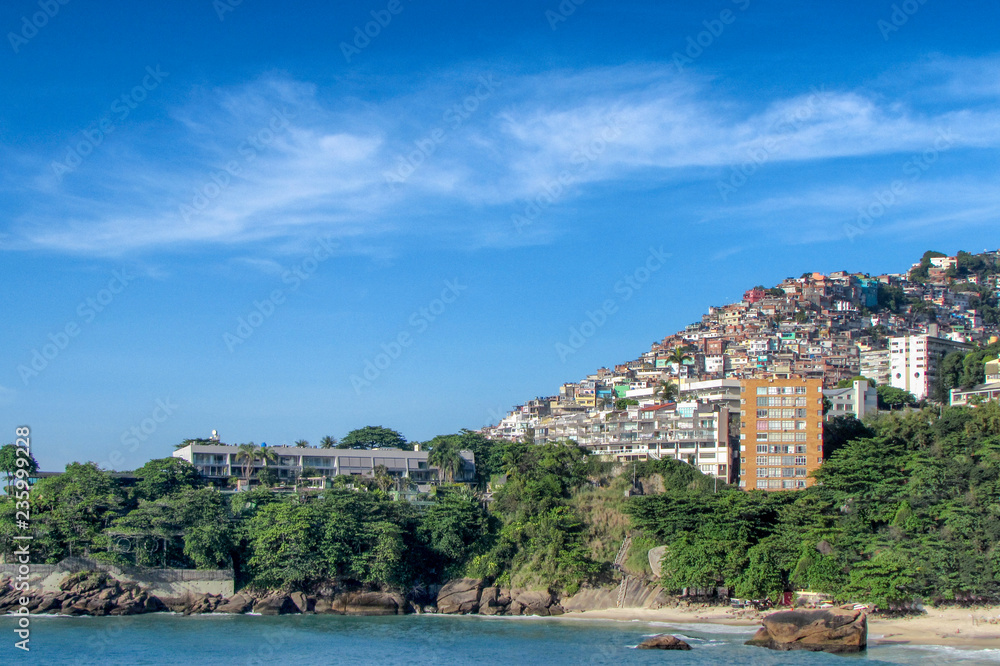 view of beautiful beach, hotel with favela in the background