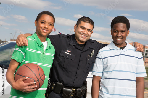 Policeman talking to kids on the street