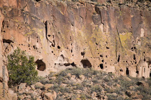 Caves and abandoned ancient ruins in a colorful cliff in Bandelier National Monument near Santa Fe, New Mexico photo