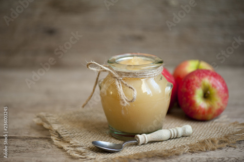 Old wooden table with fresh made Applesauce (selective focus; close-up shot) 