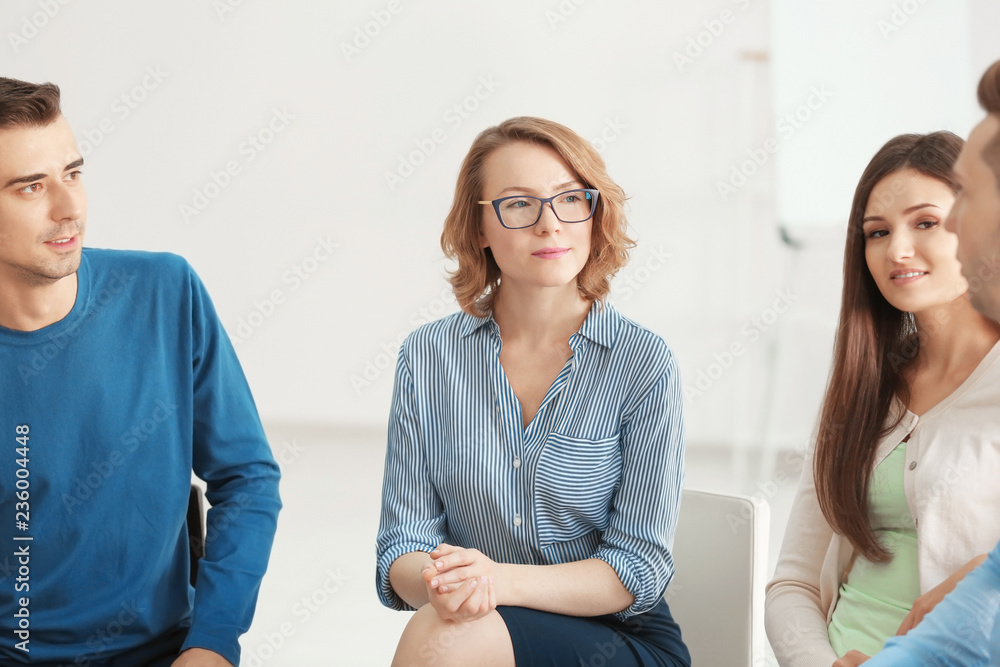 People at group psychotherapy session indoors
