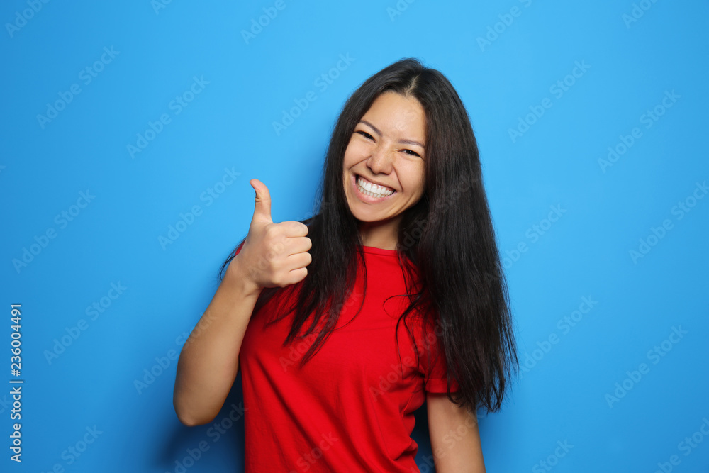 Attractive young woman posing on color background Attractive young woman posing on color background