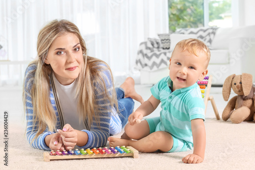 Baby and mother playing wit...