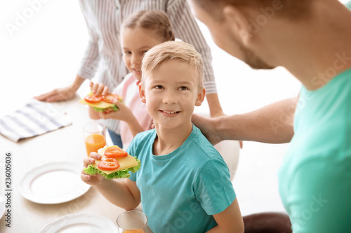 Little boy holding tasty to...