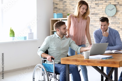 Young man in wheelchair wit...