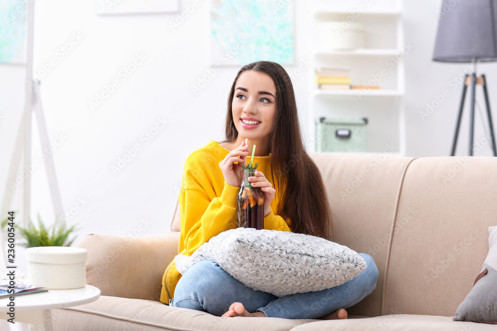 Young woman with tasty refreshing lemonade indoors Young woman with tasty refreshing lemonade indoors
